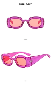 Detail view of purple-red petal sunglasses with wavy frames and wide side temples