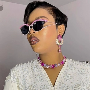 Detail of luxury pink cat-eye sunglasses and jewel set with rhinestones and gems