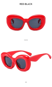 Détail de lunettes de soleil rouges à monture bulle avec verres noirs, vues de face