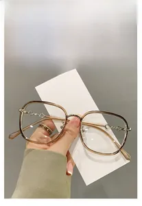 Close-up of elegant TR90 oversized brown glasses frames with golden chain temple detail