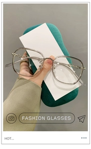 Detail of transparent TR90 frame featuring stylish silver chain metal hinges and texture