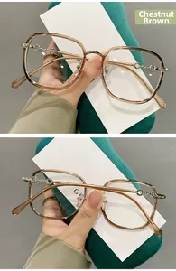 Detail view of TR90 large square frame glasses in chestnut brown with metal chain temple