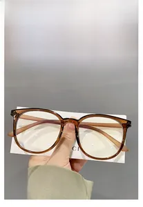 Detail shot of oversized round TR90 glasses frame in transparent amber brown color