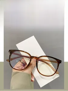 Detail shot of oversized translucent amber TR90 eyeglass frames with retro aesthetic