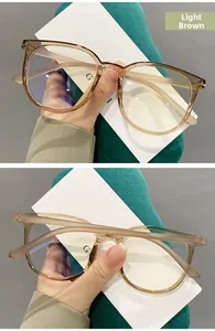 Detail of light tea colored TR90 glasses frame with metal hinges and large round design