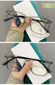 Detail view of matte grey TR90 frame with silver cross floral relief on the temples