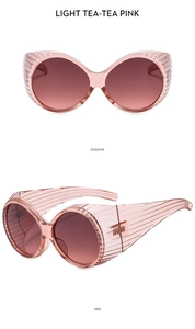 Détail macro de lunettes de soleil rose thé surdimensionnées avec rayures sur les branches