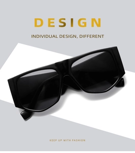Detailed view of fashionable black flat top oversized sunglasses on a minimalist background
