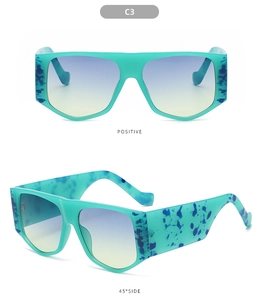 Detail view of large turquoise frame sunglasses with blue marbled temples and gradient lenses
