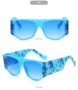 Detail view of oversized blue gradient sunglasses with marble textured wide temples