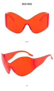 Front and side view of Y2K futuristic wrap-around oversized translucent red sunglasses