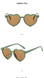 Détail de lunettes de soleil coeur vert thé pour enfants avec verres marrons