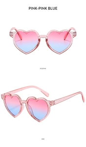 Vue détaillée des lunettes de soleil cœur rose pailleté avec verres dégradés rose et bleu