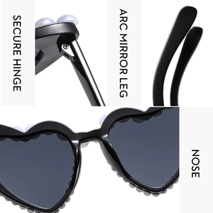 Detail view of heart-shaped sunglasses with secure hinges and comfortable nose pads
