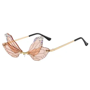 Frameless dragonfly wing sunglasses with pink gradient lenses and sparkling rhinestones