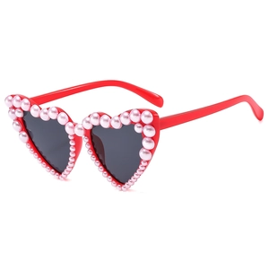 Fashion heart shaped sunglasses with red plastic frames and pink pearl embellishments