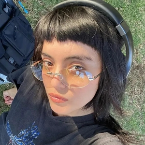 Vintage rimless oval sunglasses with metal frame in Y2K style on a fashion model