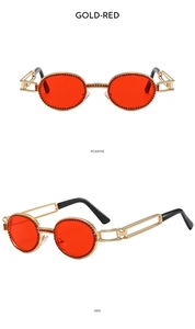 Close-up of gold punk sunglasses with red rhinestones and hollow geometric temples