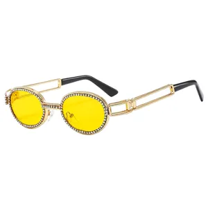 Punk style oval metal sunglasses with yellow lenses and diamond-studded gold frames