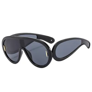 Futuristic large frame sports sunglasses in black with gold metal accents side view