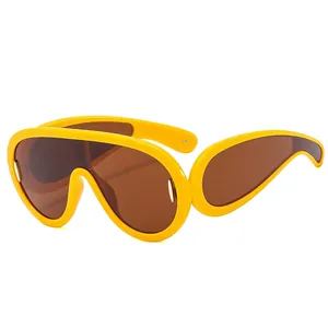 Futuristic oversized yellow frame sunglasses with brown lenses in a sporty punk style