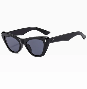 Detail of black cat eye sunglasses with silver metal rivets and dark grey lenses