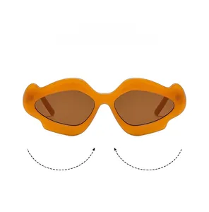 Close-up of orange wavy frames with brown lenses on these avant-garde sunglasses