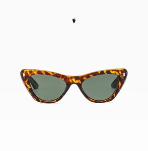 Detail view of cat eye glasses frame with demi green tortoiseshell pattern and texture