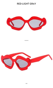 Lip-shaped red sunglasses with light gray lenses shown from front and side angles