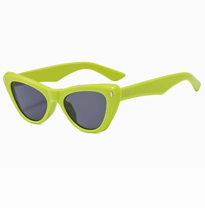 Detail of neon green cat-eye frames featuring silver metal rivets and grey lenses