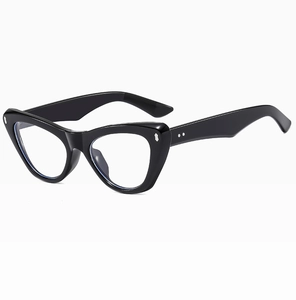 Detail of black cat-eye glasses frame with silver metal rivets and glossy finish