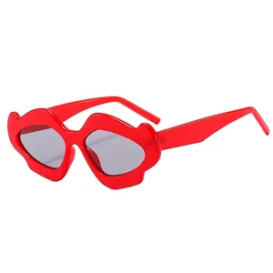 Unique lip-shaped oversized sunglasses in bright red with translucent dark grey lenses