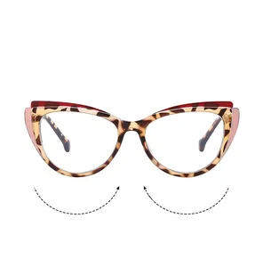 Detail of tortoiseshell cat-eye glasses frame with red wave accents and pink trim accents