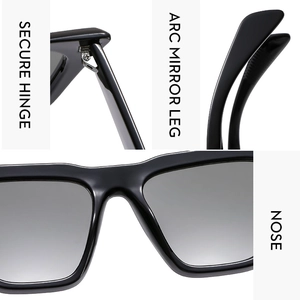 Detail of oversized sunglasses featuring secure metal hinges and polished black frames