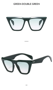 Detail view of dark green thick-frame sunglasses with star accents and gradient lenses
