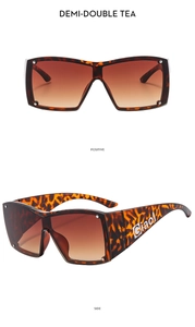 Detail view of square tortoiseshell sunglasses with gradient tea lenses and wide temples