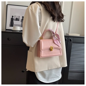 Pink square leather crossbody bag with floral scarf handle and gold hardware detail