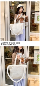 White quilted puffer tote bag detail, soft cloud handbag shoulder design for daily use.