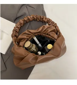 Interior view of brown pleated cloud bag showing large capacity and zipper pocket