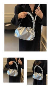 Detail of silver metallic pleated cloud bag featuring soft ruched texture and strap