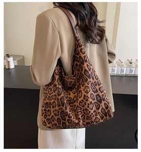 Detail of large leopard print tote bag with thick suede texture and brown leather strap