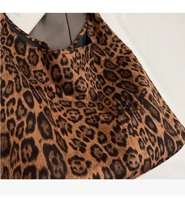 Close-up of leopard print tote bag fabric with soft suede texture and brown patterns