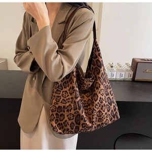 Close-up of stylish leopard print shoulder bag in plush fabric styled with an autumn blazer