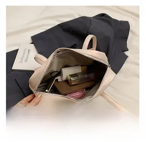 Top view of cream leather bowling bag showing spacious interior with daily essentials