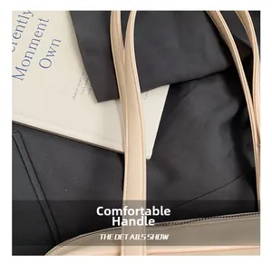 Close-up of cream leather handles with fine stitching on a vintage bowling bag