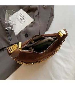 Detailed interior view of a brown suede hobo bag showing spacious capacity for essentials