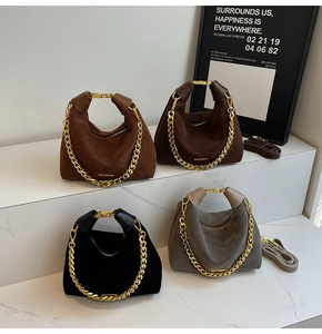 Multiple colors of matte suede pillow bags with metallic handles and chain details