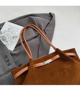 Detailed top view of large brown suede tote bag with leather strap and magnetic closure