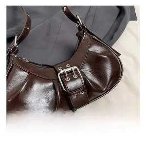 Detailed macro view of dark brown glossy patent leather with silver metal buckle decor