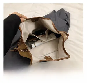Interior view showing large capacity tote bag with herringbone lining and pockets